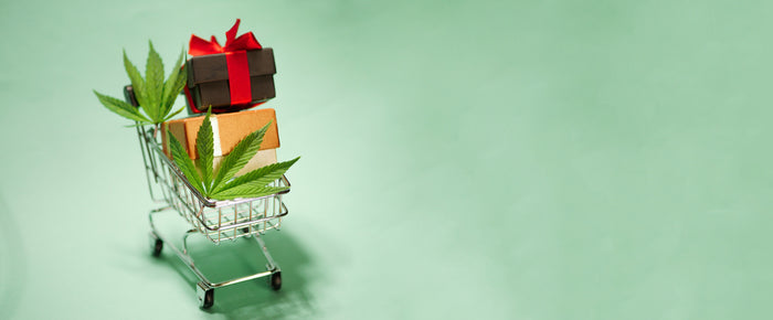 Cannabis leaf with shopping cart. Christmas gifts. New Year sale banner. Marijuana online store. 