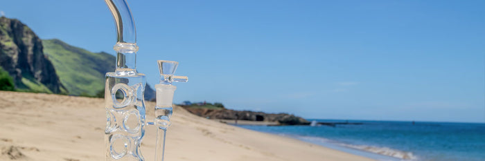 Glass dab rig on a beach in summer 