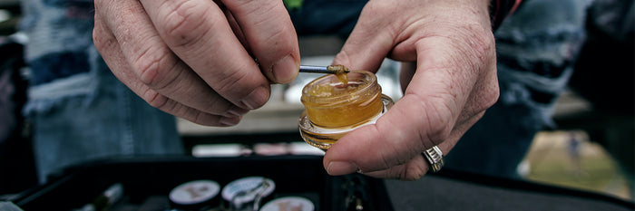 A man holding a container of medical cannabis extract